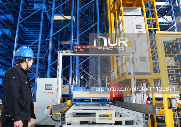 A worker is scanning product codes at a workshop of an equipment manufacturing company in Zaozhuang, Shandong Province, China, on April 7, 2...