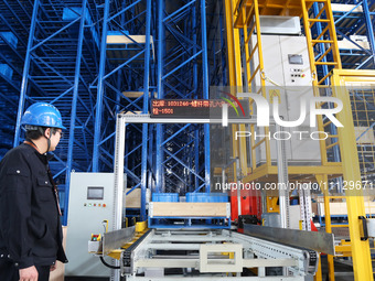 A worker is scanning product codes at a workshop of an equipment manufacturing company in Zaozhuang, Shandong Province, China, on April 7, 2...