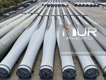 Wind turbine blades are being manufactured at a company in Yangzhou, China, on April 8, 2024. (