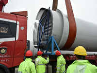 Workers are fixing wind power blades in Yangzhou, East China's Jiangsu province, on April 8, 2024. (