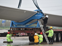 Workers are fixing wind power blades in Yangzhou, East China's Jiangsu province, on April 8, 2024. (