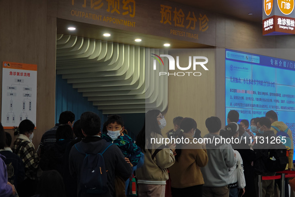 Parents are taking their children to see a doctor at a hospital in Shanghai, China, on April 9, 2024. 