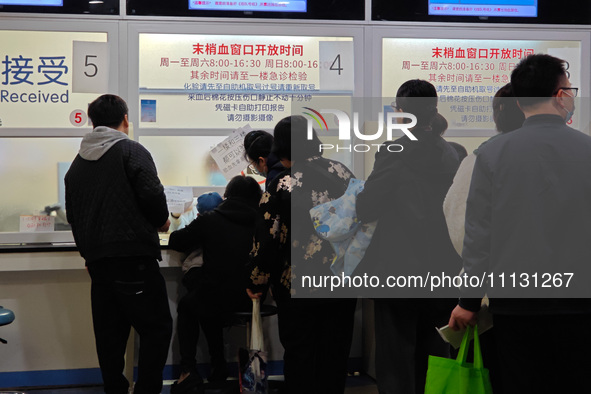 Parents are taking their children to see a doctor at a hospital in Shanghai, China, on April 9, 2024. 