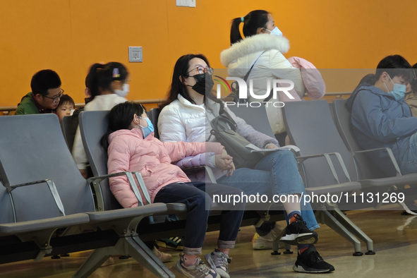 Parents are taking their children to see a doctor at a hospital in Shanghai, China, on April 9, 2024. 