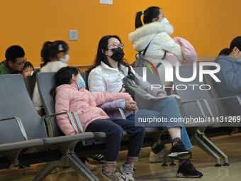 Parents are taking their children to see a doctor at a hospital in Shanghai, China, on April 9, 2024. (