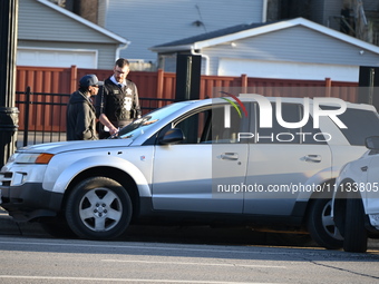 Vehicles are damaged at the crime scene where a 4-year-old boy is in critical condition after being shot in broad daylight in Chicago, Illin...