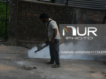 A municipal worker is fumigating a residential area as a preventive measure against disease-carrying mosquitoes in Siliguri, India, on April...