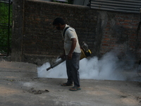 A municipal worker is fumigating a residential area as a preventive measure against disease-carrying mosquitoes in Siliguri, India, on April...