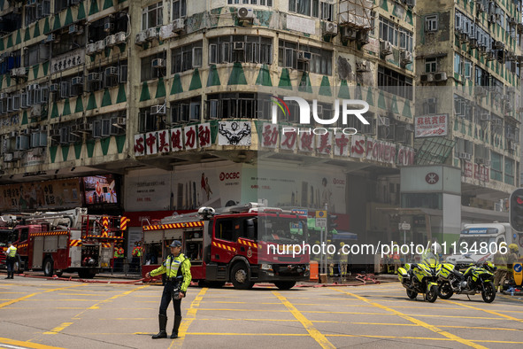 A general view is showing the building that is on fire in Hong Kong's Jordan District on April 10, 2024. The fire has resulted in 5 deaths a...