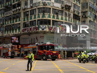 A general view is showing the building that is on fire in Hong Kong's Jordan District on April 10, 2024. The fire has resulted in 5 deaths a...