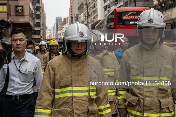 Hong Kong Secretary for Security Chris Tang Ping-keung is dressed in a firefighter's uniform and wearing a firefighter's helmet as he arrive...