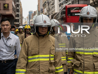 Hong Kong Secretary for Security Chris Tang Ping-keung is dressed in a firefighter's uniform and wearing a firefighter's helmet as he arrive...