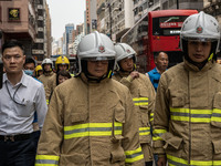 Hong Kong Secretary for Security Chris Tang Ping-keung is dressed in a firefighter's uniform and wearing a firefighter's helmet as he arrive...