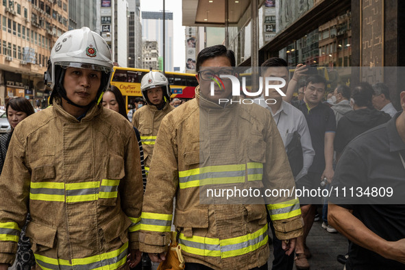 Hong Kong Secretary for Security Chris Tang Ping-keung is dressed in a firefighter's uniform at the scene of the building fire in Hong Kong'...