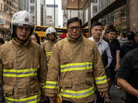 Hong Kong Secretary for Security Chris Tang Ping-keung is dressed in a firefighter's uniform at the scene of the building fire in Hong Kong'...