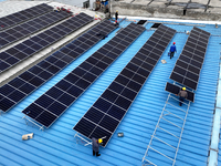 Workers are installing solar photovoltaic panels on the roof of a factory in Haian, Jiangsu Province, China, on April 11, 2024. (