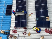 Workers are installing solar photovoltaic panels on the roof of a factory in Haian, Jiangsu Province, China, on April 11, 2024. (