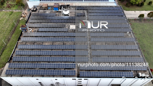 Workers are installing solar photovoltaic panels on the roof of a factory in Haian, Jiangsu Province, China, on April 11, 2024. 