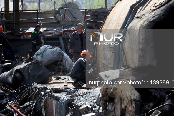 Workers are seen at the damaged Kharkiv Combined Heat and Power Plant (CHP) in the Kharkiv Region, northeastern Ukraine, on April 11, 2024....