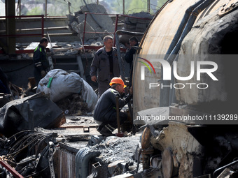 Workers are seen at the damaged Kharkiv Combined Heat and Power Plant (CHP) in the Kharkiv Region, northeastern Ukraine, on April 11, 2024....