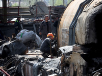 Workers are seen at the damaged Kharkiv Combined Heat and Power Plant (CHP) in the Kharkiv Region, northeastern Ukraine, on April 11, 2024....