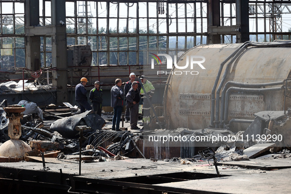 Workers are seen at the damaged Kharkiv Combined Heat and Power Plant (CHP) in the Kharkiv Region, northeastern Ukraine, on April 11, 2024....