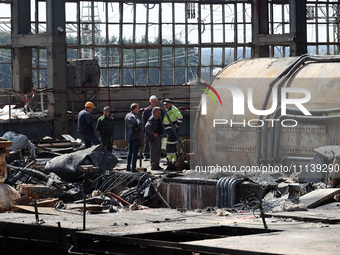 Workers are seen at the damaged Kharkiv Combined Heat and Power Plant (CHP) in the Kharkiv Region, northeastern Ukraine, on April 11, 2024....