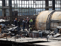 Workers are seen at the damaged Kharkiv Combined Heat and Power Plant (CHP) in the Kharkiv Region, northeastern Ukraine, on April 11, 2024....