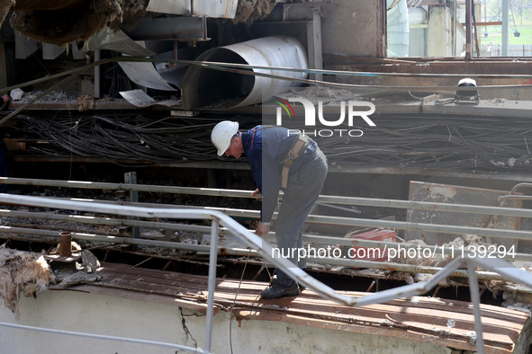 A worker is inspecting the damage at the Kharkiv Combined Heat and Power Plant (CHP) in the Kharkiv Region, northeastern Ukraine, on April 1...