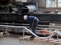 A worker is inspecting the damage at the Kharkiv Combined Heat and Power Plant (CHP) in the Kharkiv Region, northeastern Ukraine, on April 1...