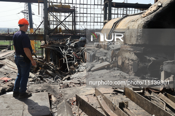 A worker is inspecting the damage at the Kharkiv Combined Heat and Power Plant (CHP) in the Kharkiv Region, northeastern Ukraine, on April 1...