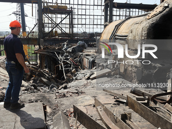 A worker is inspecting the damage at the Kharkiv Combined Heat and Power Plant (CHP) in the Kharkiv Region, northeastern Ukraine, on April 1...