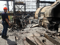 A worker is inspecting the damage at the Kharkiv Combined Heat and Power Plant (CHP) in the Kharkiv Region, northeastern Ukraine, on April 1...