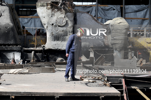 A worker is inspecting the damage at the Kharkiv Combined Heat and Power Plant (CHP) in the Kharkiv Region, northeastern Ukraine, on April 1...