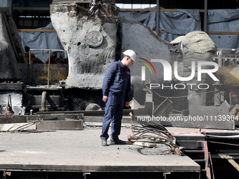 A worker is inspecting the damage at the Kharkiv Combined Heat and Power Plant (CHP) in the Kharkiv Region, northeastern Ukraine, on April 1...