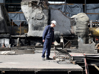 A worker is inspecting the damage at the Kharkiv Combined Heat and Power Plant (CHP) in the Kharkiv Region, northeastern Ukraine, on April 1...