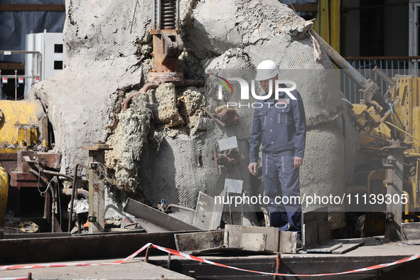 A worker is inspecting the damage at the Kharkiv Combined Heat and Power Plant (CHP) in the Kharkiv Region, northeastern Ukraine, on April 1...