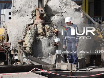 A worker is inspecting the damage at the Kharkiv Combined Heat and Power Plant (CHP) in the Kharkiv Region, northeastern Ukraine, on April 1...