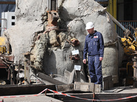 A worker is inspecting the damage at the Kharkiv Combined Heat and Power Plant (CHP) in the Kharkiv Region, northeastern Ukraine, on April 1...