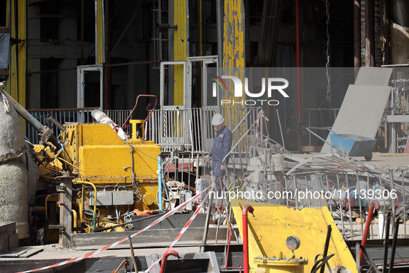 A worker is inspecting the damage at the Kharkiv Combined Heat and Power Plant (CHP) in the Kharkiv Region, northeastern Ukraine, on April 1...