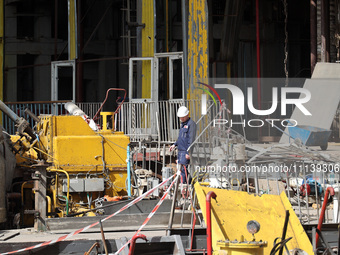 A worker is inspecting the damage at the Kharkiv Combined Heat and Power Plant (CHP) in the Kharkiv Region, northeastern Ukraine, on April 1...