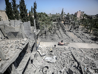 Palestinians are inspecting the damage in a residential building in Deir Al-Balah, in the central Gaza Strip, following Israeli air strikes...