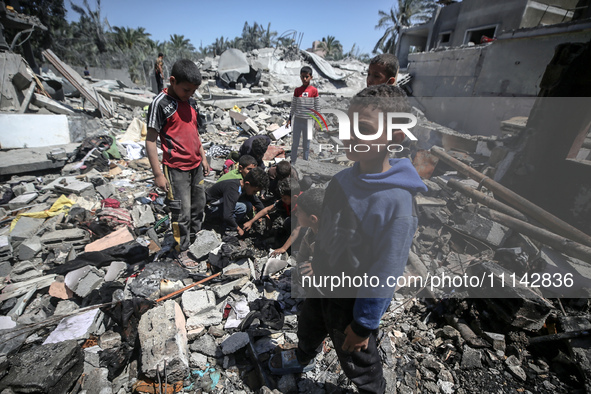 Palestinians are inspecting the damage in a residential building in Deir Al-Balah, in the central Gaza Strip, following Israeli air strikes...