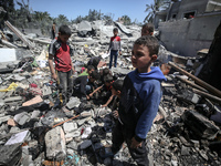 Palestinians are inspecting the damage in a residential building in Deir Al-Balah, in the central Gaza Strip, following Israeli air strikes...