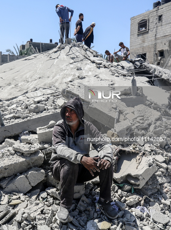 Palestinians are inspecting the damage in a residential building in Deir Al-Balah, in the central Gaza Strip, following Israeli air strikes...