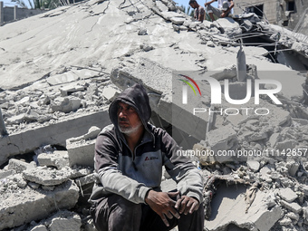 Palestinians are inspecting the damage in a residential building in Deir Al-Balah, in the central Gaza Strip, following Israeli air strikes...