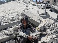 Palestinians are inspecting the damage in a residential building in Deir Al-Balah, in the central Gaza Strip, following Israeli air strikes...