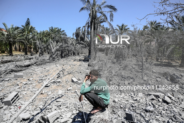 Palestinians are inspecting the damage in a residential building in Deir Al-Balah, in the central Gaza Strip, following Israeli air strikes...