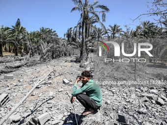 Palestinians are inspecting the damage in a residential building in Deir Al-Balah, in the central Gaza Strip, following Israeli air strikes...