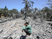 Palestinians are inspecting the damage in a residential building in Deir Al-Balah, in the central Gaza Strip, following Israeli air strikes...